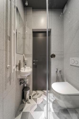 a bathroom with a toilet and a sink at Old City apart in Lviv