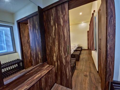 a hallway with wooden walls and benches in a room at Tathastu Tadoba in Mohurli