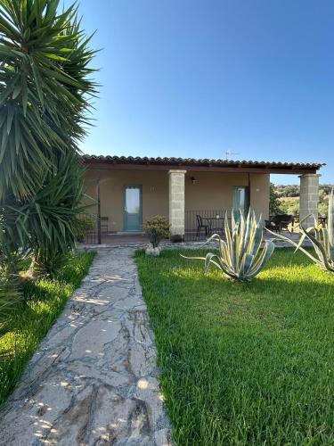 a house with a pathway in front of a yard at Borgo Nocchiara in Carlentini