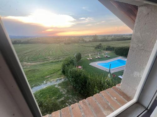 a view of a swimming pool from a window at Nido nel verde in Grazzano Visconti