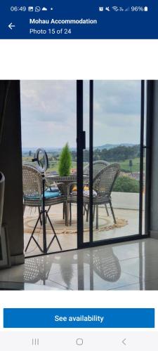 a view of a table and chairs through a window at Mohau Accommodation and Events GRACE in Elandsfontein