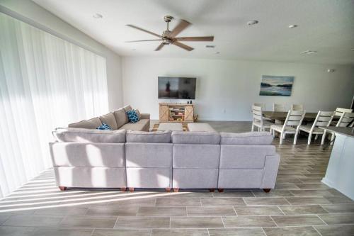 a living room with a couch and a ceiling fan at A Getaway Home in The Clouds in Pine Grove