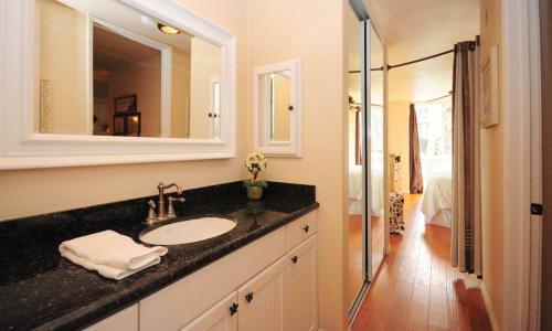 a bathroom with a sink and a mirror at Northcoast Village ocean views in Oceanside
