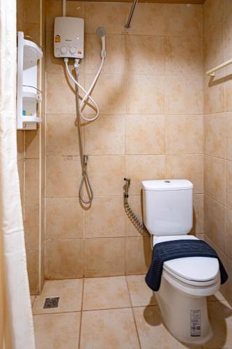 a bathroom with a toilet and a shower at JB House Patong in Patong Beach