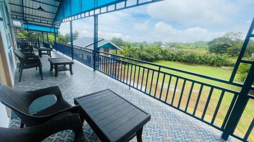 a balcony with a table and chairs and a view at MGM Whispering Wind's Yelagiri in Yelagiri