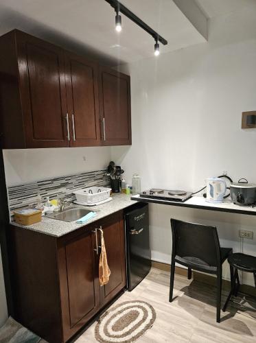 a kitchen with wooden cabinets and a table and chairs at Weyh's Studio #1 by the ocean 100Mbps in Panglao