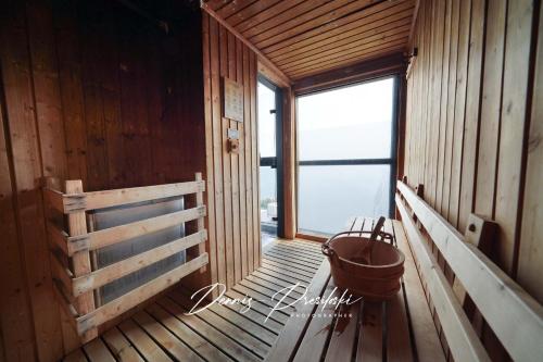 a wooden room with a large window and a bucket at Luxury Edge Seaview Apartment in Pattaya Central
