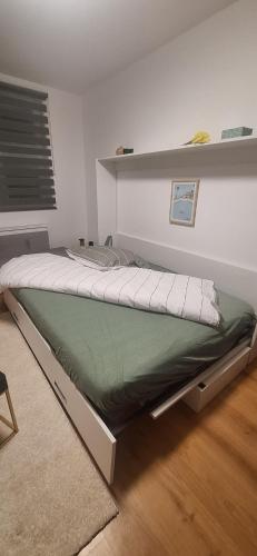 a large bed in a room with at L'Eldorado du Léman in Annemasse