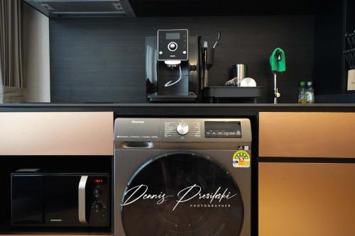 a washing machine in a kitchen with a counter at Luxury Edge Seaview Apartment in Pattaya Central