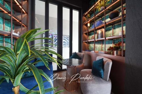 a living room with a chair and a plant at Luxury Edge Seaview Apartment in Pattaya Central