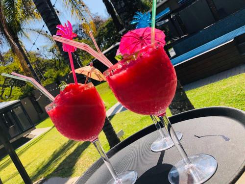 two cocktails in wine glasses sitting on a table at 30 on Bergh in Louis Trichardt