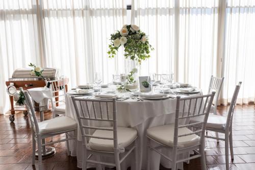 a white table with chairs and a white table cloth at Hotel Mirasole International in Gaeta