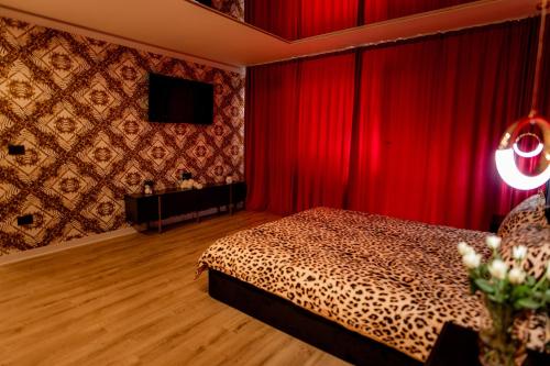 a bedroom with a bed and a red curtain at Desire Loft in Alba Iulia