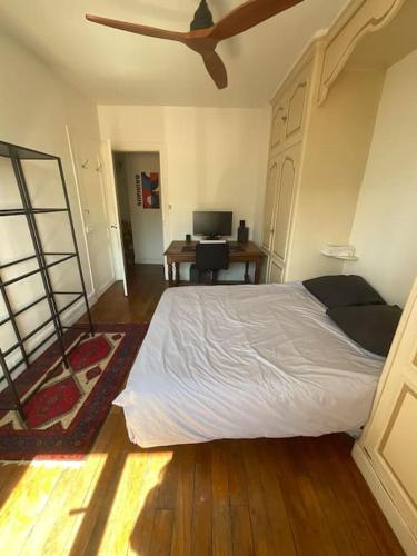 une chambre avec un grand lit et un bureau dans l'établissement Nice entire apartment 15 minutes from Paris, à Joinville-le-Pont