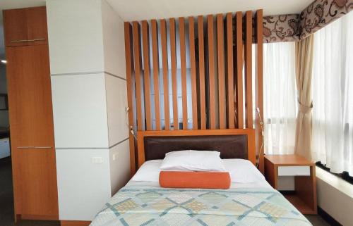 Ένα ή περισσότερα κρεβάτια σε δωμάτιο στο Fuente Oro Business Suites Cebu