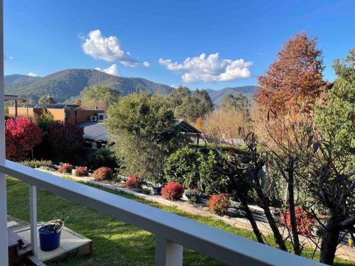 a view of a garden from the balcony of a house at Guesthouse with a view in Bright