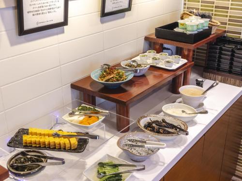 a buffet with bowls of food on a counter at Akihabara Washington Hotel in Tokyo