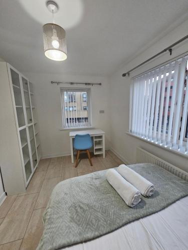 a bedroom with a bed and a desk and a window at 66 Central Road in Kent