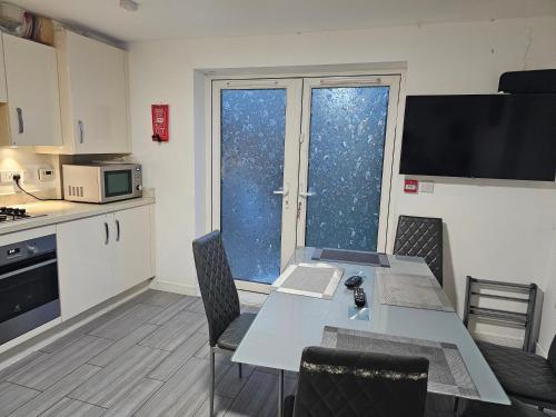 a kitchen with a table with a laptop on it at 66 Central Road in Kent