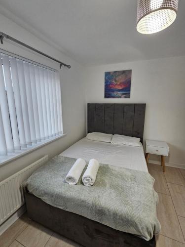 a bedroom with a bed with two towels on it at 66 Central Road in Kent