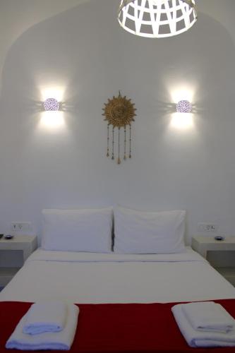 a bedroom with a bed with two sinks and two lights at Mary Castelia Villa with Jacuzzi in Akrotiri