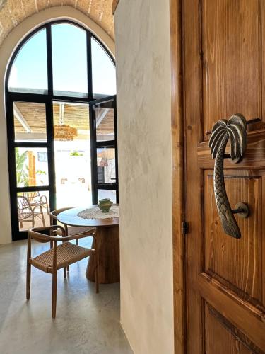 a dining room with a table and a door at Midi Pool Villa & SPA in Veglie