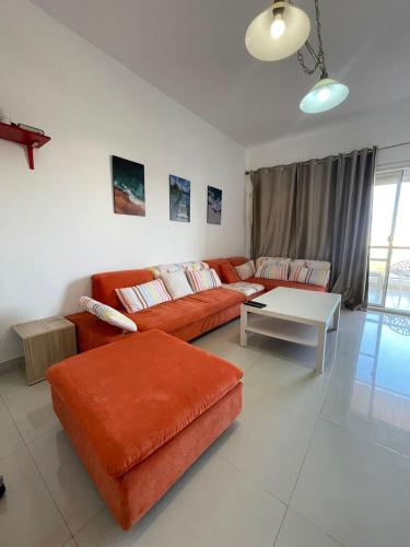 a living room with a couch and a table at VIP Chalet Amwaj North Cost E Zone The Terrace in El Alamein