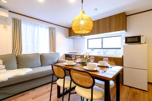 a kitchen and living room with a table and chairs at Kichijoji Urban Retreat - 2F Boutique House - Steps to Inokashira Park & Ghibli Museum アキサポステイ吉祥寺 in Kichijōji