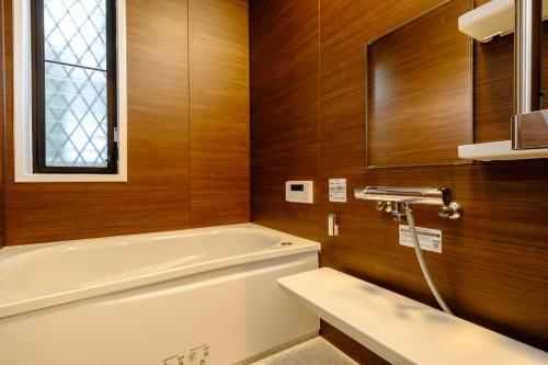 a bathroom with a tub and a toilet and a sink at Kichijoji Urban Retreat - 2F Boutique House - Steps to Inokashira Park & Ghibli Museum アキサポステイ吉祥寺 in Kichijōji