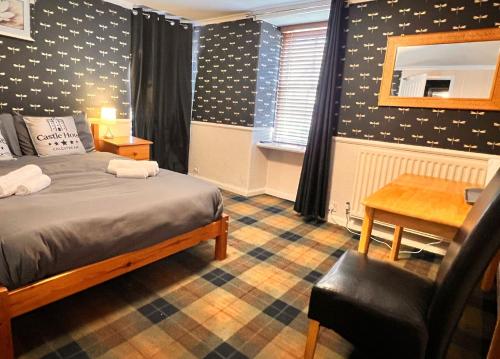 a bedroom with a bed and a desk and a chair at Modern Rooms with SELF Check-In The Castle, Coldstream in Coldstream