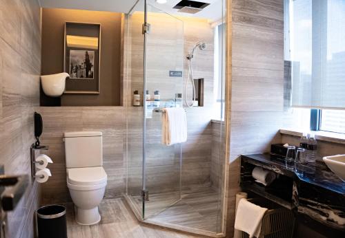a bathroom with a shower and a toilet and a sink at Pullman Shanghai Jing'an-Jing'an district, downtown railway station, traffic hub, easy to travel Shanghai in Shanghai
