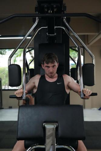 a man sitting in a gym on a machine at Irene Pool Villa Resort, Koh Lipe in Ko Lipe