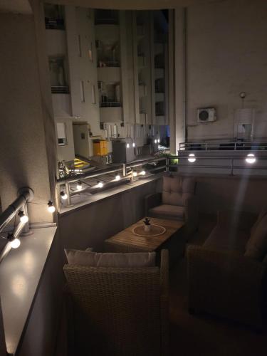 a room with a table and chairs and lights at Dule Lux in Jagodina