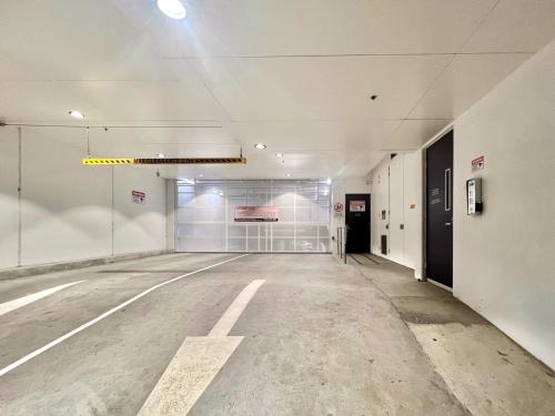 an empty parking garage with an empty parking lot at Indulge Luxury Holiday Near Brighton Beach with Private Garden Parking in Melbourne