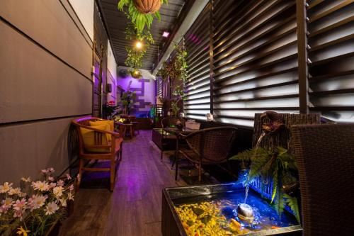 a room with a fish tank and a table and chairs at Shalom Suites in Kota Kinabalu
