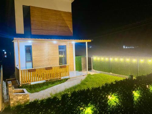 une maison avec des lumières sur son côté la nuit dans l'établissement Cottage Marta Sadgeri, à Bordjomi