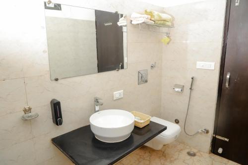 a bathroom with a sink and a toilet at Pearl of Taj Home Stay in Agra