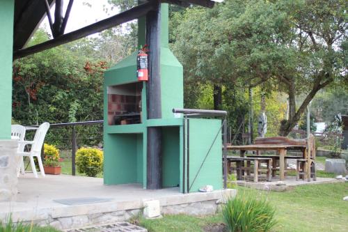 a green oven with a fire hydrant in a yard at WaraKusi Country Houses - Off Road in Salta