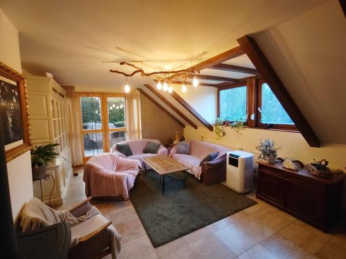 a living room with a couch and a table at RichiLak in Visegrád