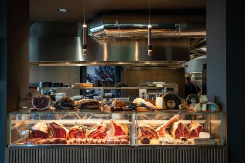 a display case in a bakery with meats and pastries at MòN Luxury Rooms SPA in Nicolosi