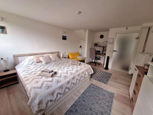 a bedroom with a bed with a white comforter at Hygge Apartment in Warstein