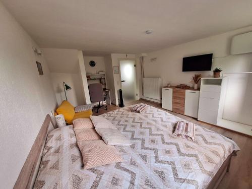a bedroom with a large bed with pillows on it at Hygge Apartment in Warstein
