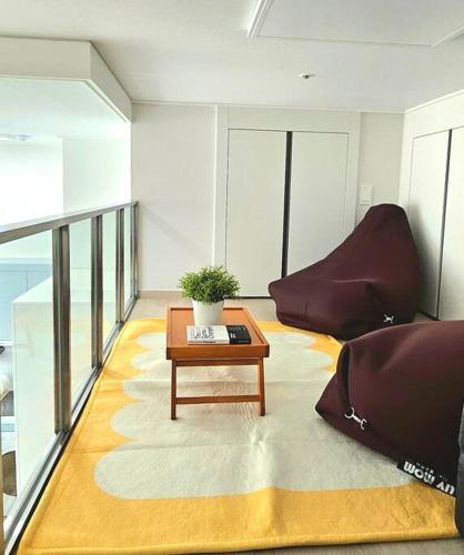 a living room with a couch and a coffee table at Majestic Seoul Stay Central in Seoul