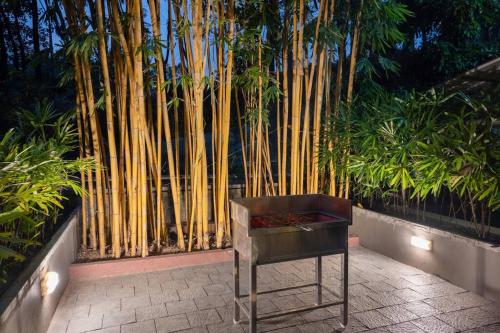 a chair sitting in front of a bamboo fence at 2 premium rooms with pool&by lake close to Vagamon in Muttam