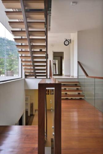 a room with a staircase in a building at 2 premium rooms with pool&by lake close to Vagamon in Muttam