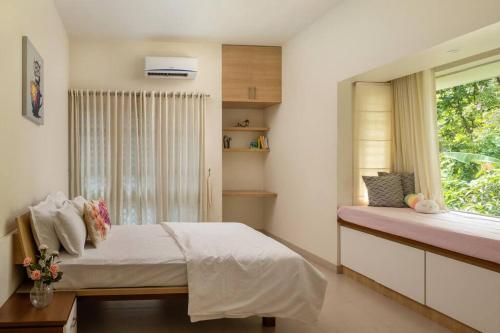 a bedroom with a bed and a window at 2 premium rooms with pool&by lake close to Vagamon in Muttam