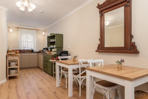 a kitchen with a table and a mirror on the wall at Délceg Réce Minihotel in Balatonkenese