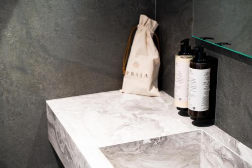 two bottles of wine on a counter with a bag at MòN Luxury Rooms SPA in Nicolosi