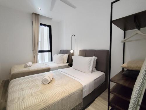 two beds in a room with a mirror at Lumi Tropicana in Petaling Jaya