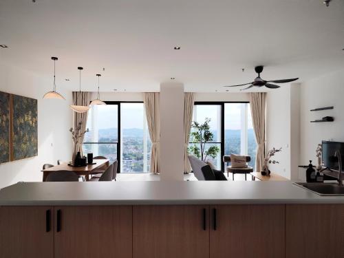 a kitchen and living room with a table and chairs at Lumi Tropicana in Petaling Jaya